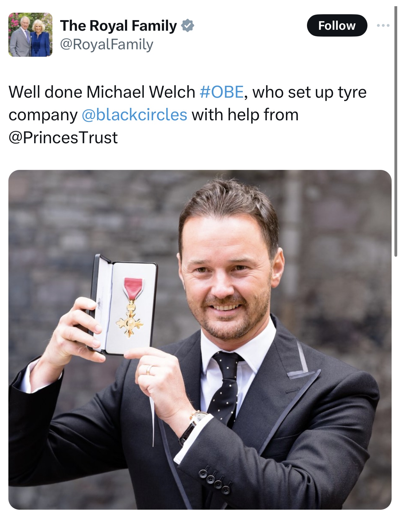 Screenshot of a post from the official Royal Family account congratulating Michael Welch on his OBE, above a photograph of him holding the OBE medal in its case outside the investiture.